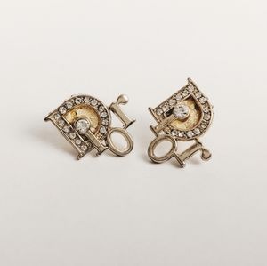 Dior gold logo earrings